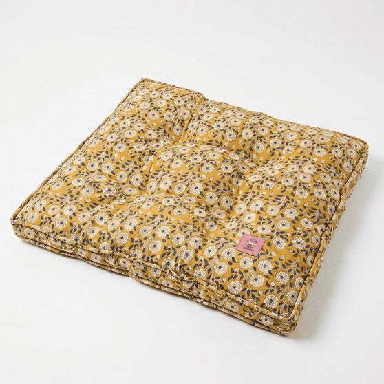 Floral-patterned cushion on a white background