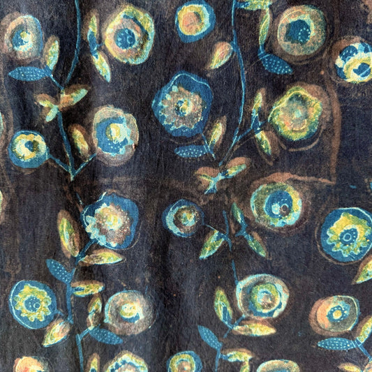 Floral pattern with blue and green flowers on a dark background