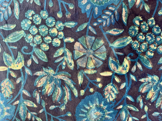 floral patterned fabric with blue and green colors on a dark background