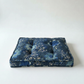 Blue floral patterned cushion on a white background