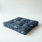 Blue floral-patterned pet bed on a white background