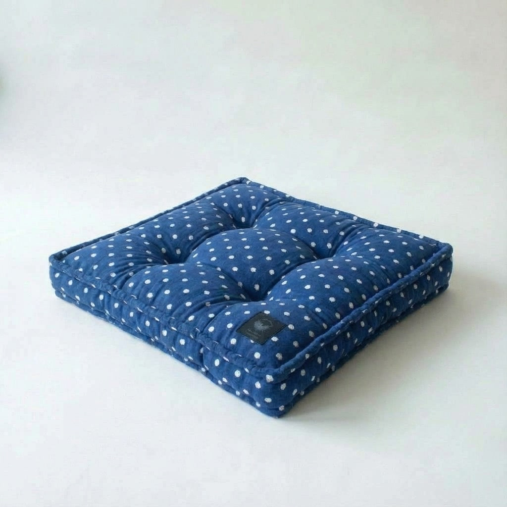 Blue polka dot cushion on a white background