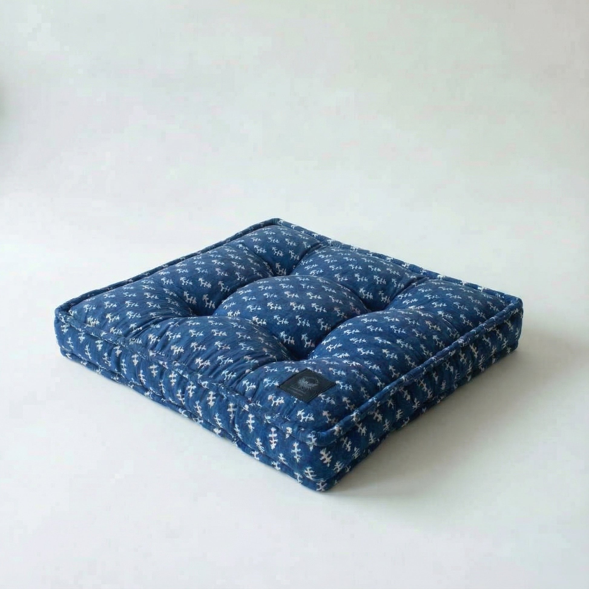 Blue patterned pet bed on a white background