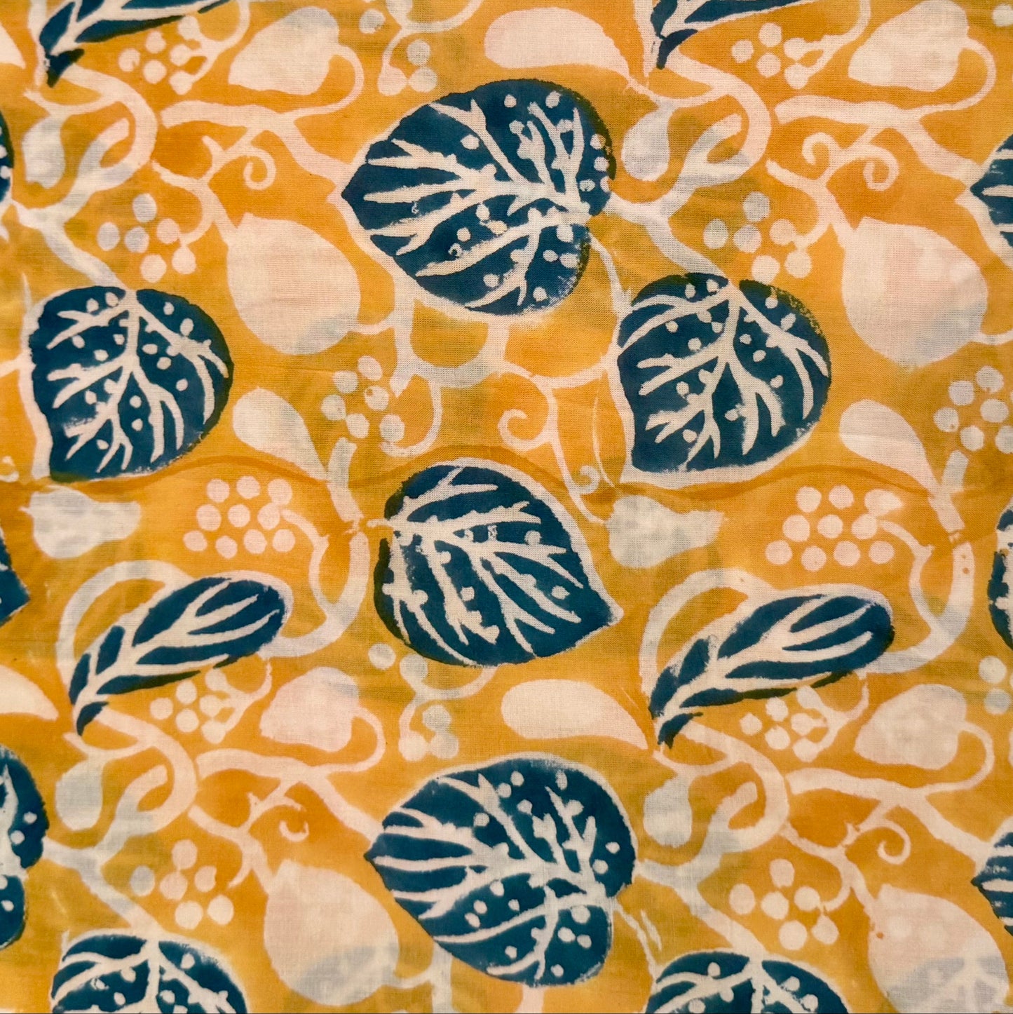 Fabric with blue leaf pattern on a yellow background