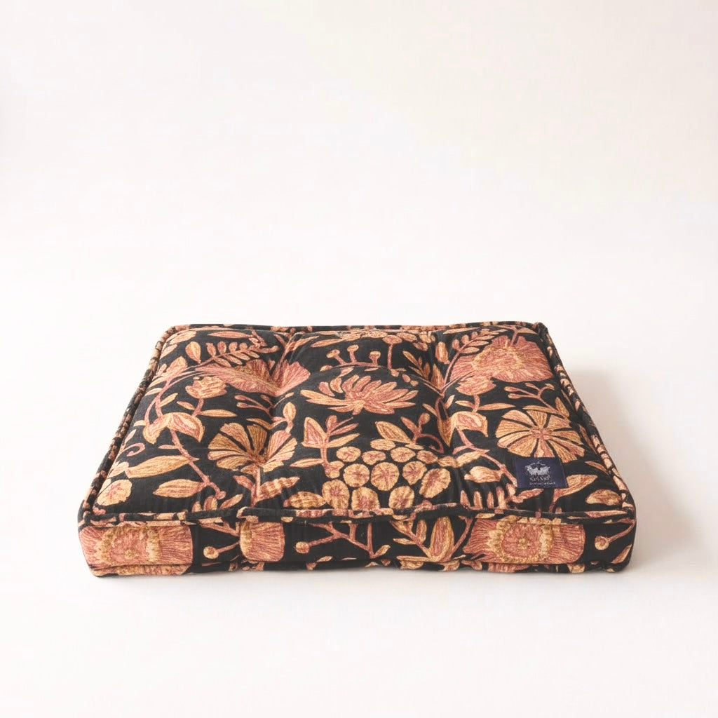 Floral patterned pet bed on a white background