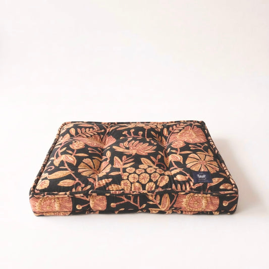 Floral patterned pet bed on a white background