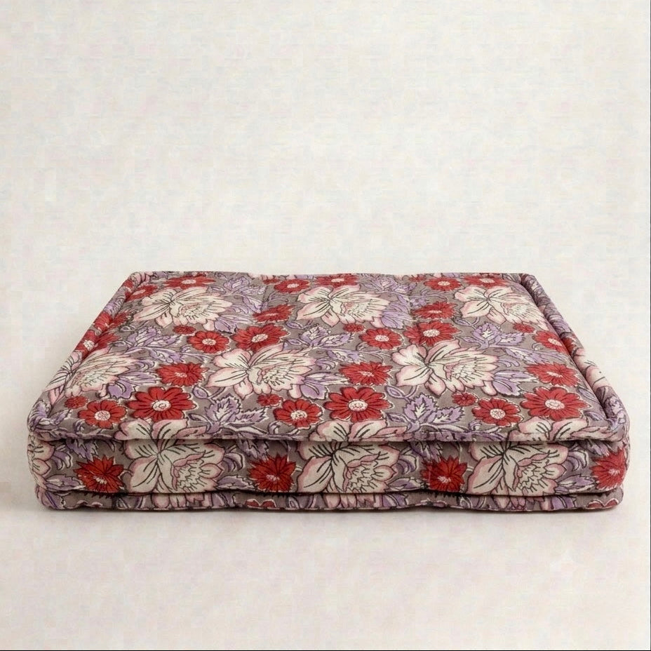 Floral-patterned pet bed on a white background