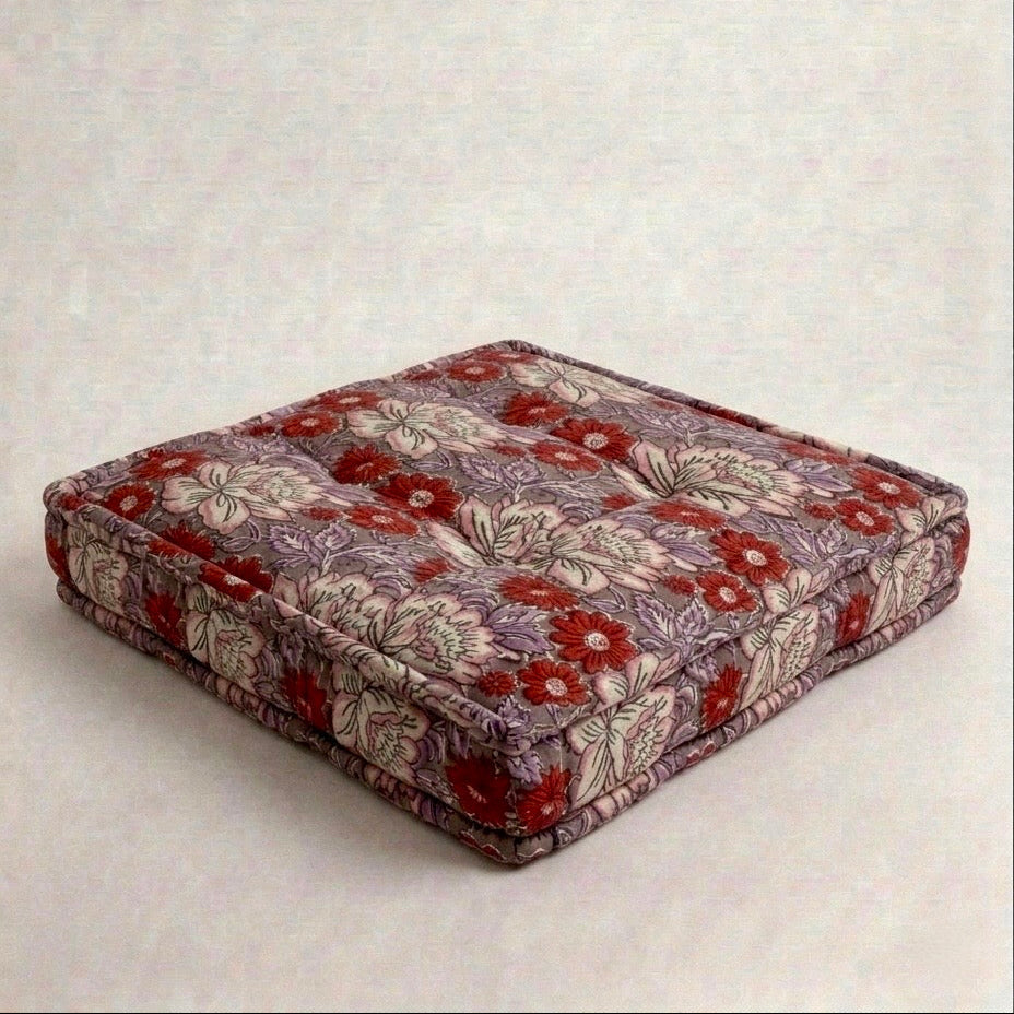 Floral patterned seat cushion on a light gray background