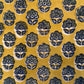 Patterned fabric with blue floral designs on a yellow background