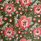 Floral pattern with pink flowers and blue leaves on a green background