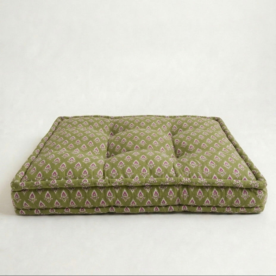 Green patterned pet bed on a white background