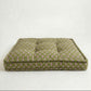 Green patterned pet bed on a white background