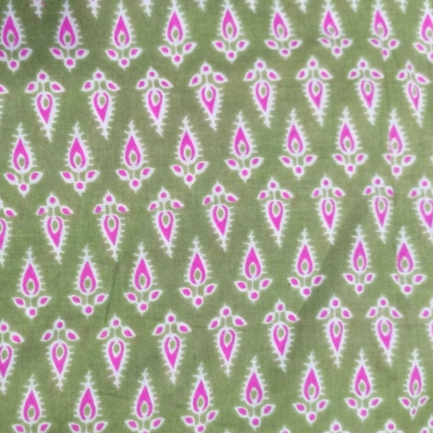 Patterned fabric with pink and white design on a green background