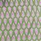 Patterned fabric with pink and white design on a green background