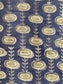 Patterned fabric with oval sblue hapes and leaf-like designs on gray background