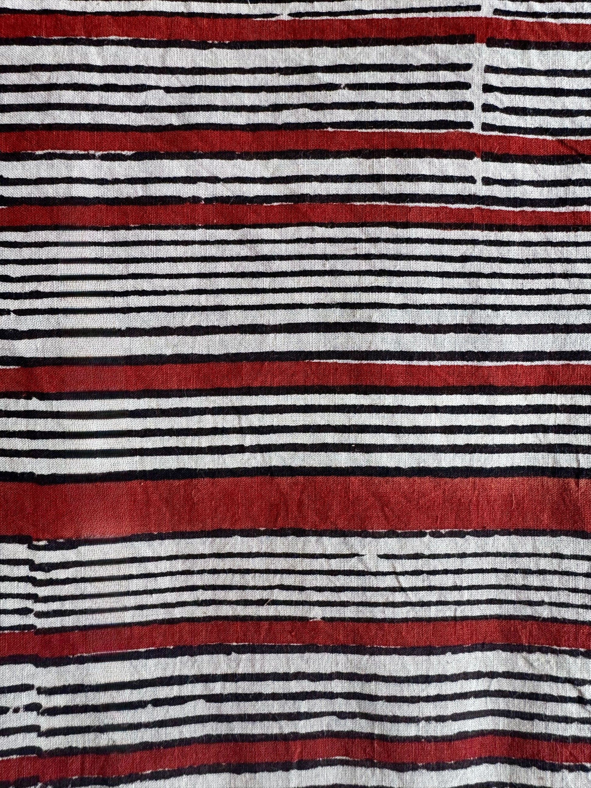 Striped fabric with red, black, and white horizontal lines
