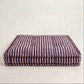 Striped pet bed on a white background