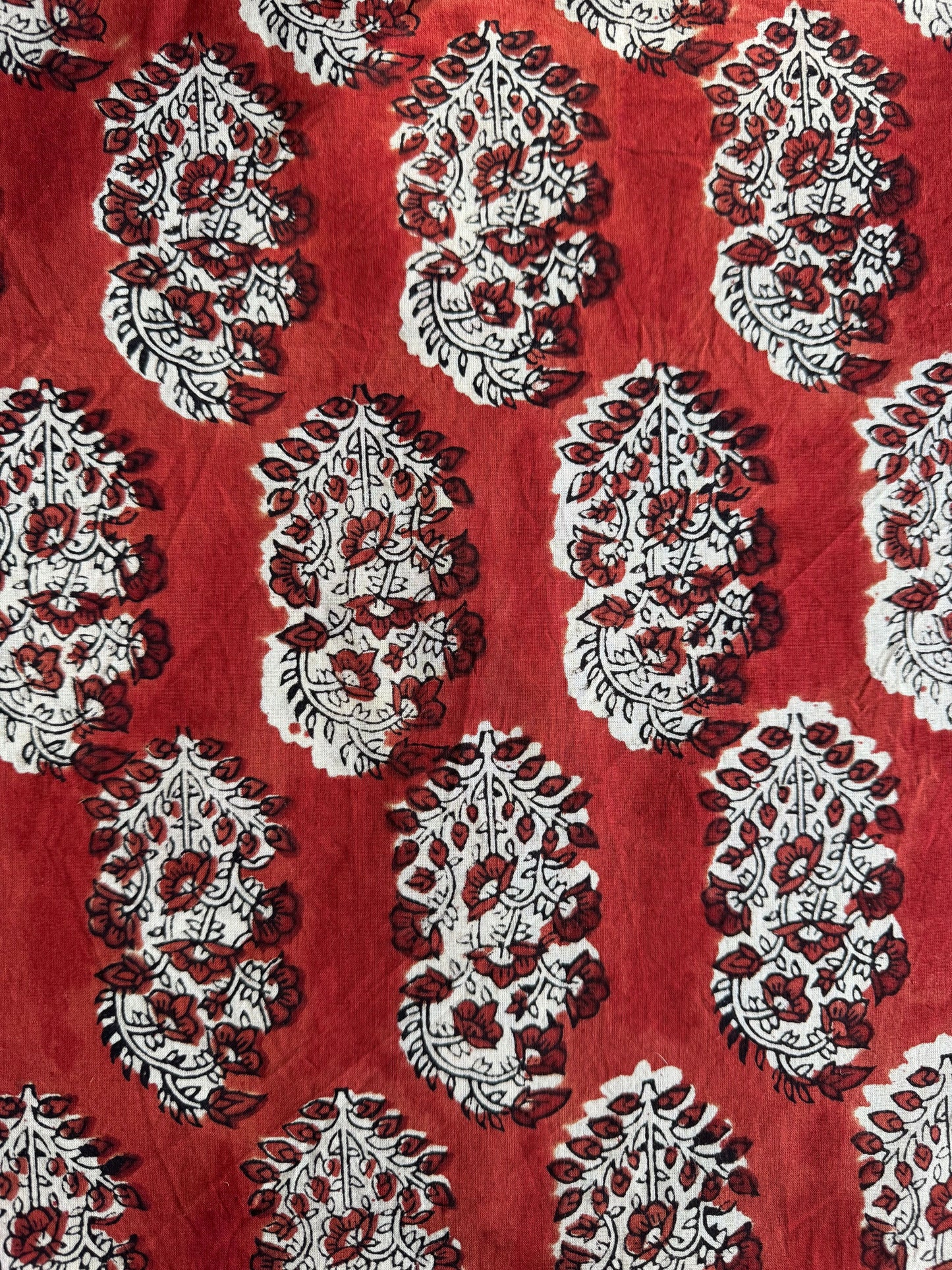 Red fabric with white and maroon paisley pattern