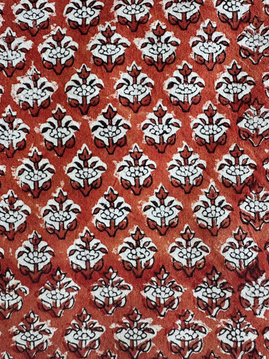 Patterned fabric with white floral design on a red background