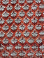 Patterned fabric with white floral design on a red background