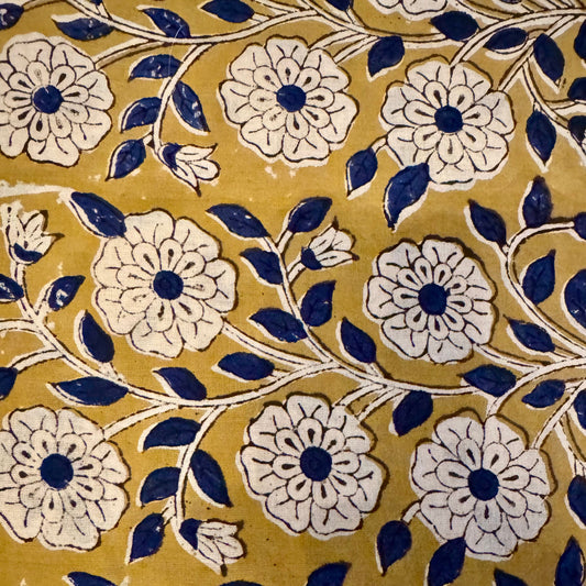 Pattern of white flowers with blue centers on a yellow background