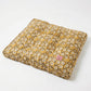 Floral-patterned cushion on a white background