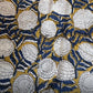 Close-up of a floral pattern with white flowers on a gold and blue background