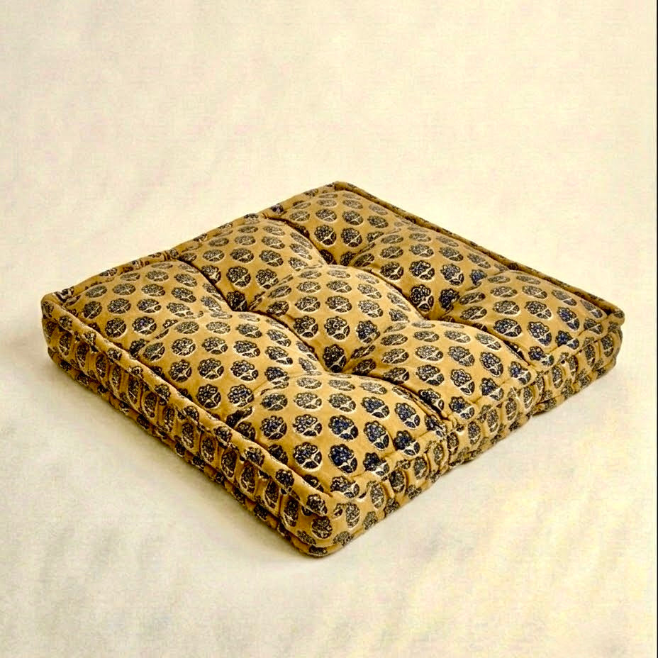 Yellow blue and green print pet bed on a beige background