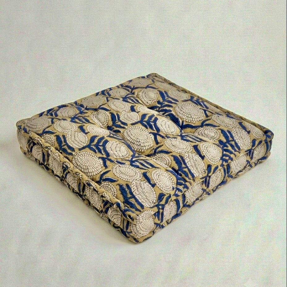 Decorative cushion with blue and beige pattern on a white background